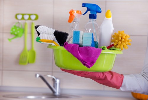 Carpet cleaner preparing equipment safely in East Barnet home